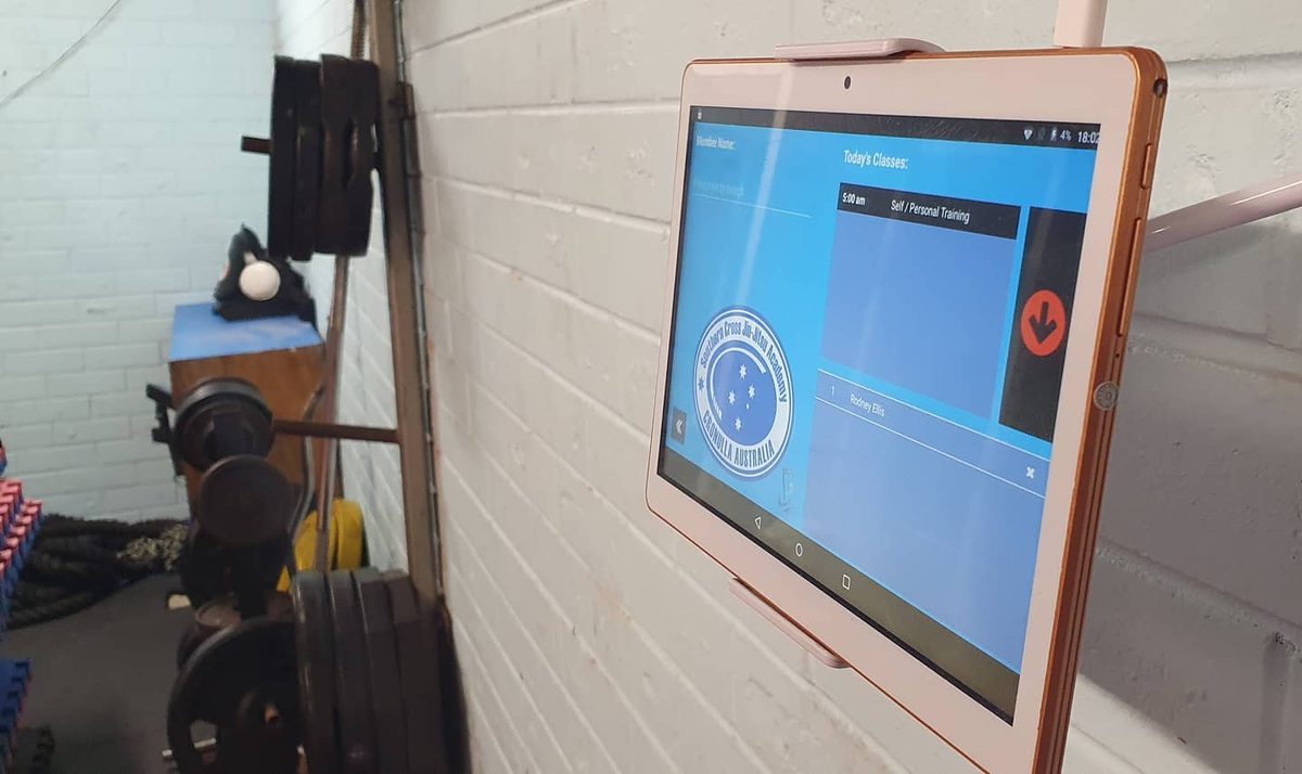 Arnold reception app running on an Android tablet mounted at a gym front desk